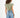 Back view of Gravity Grey padded muscle tee with structured shoulders and raw-hem denim shorts for a streetwear aesthetic.