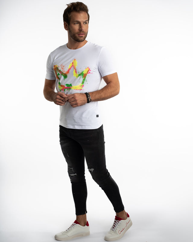 Model wearing a white Painted King Graphic Streetwear Tee with a colorful crown print and distressed black jeans.