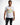 Model wearing a white Painted King graphic streetwear tee with a colorful paint-splatter crown and distressed black jeans.