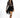 Model in Harlow black mini fringe skirt with a tan patterned long-sleeve top and heels against a white background.