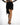 Model wearing Harlow Black Mini Skirt featuring a draped wrap front, asymmetrical hem, and black fringe tassel trim.
