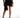 Harlow black satin mini skirt with fringe hem and wrap detail on model, paired with high heels.