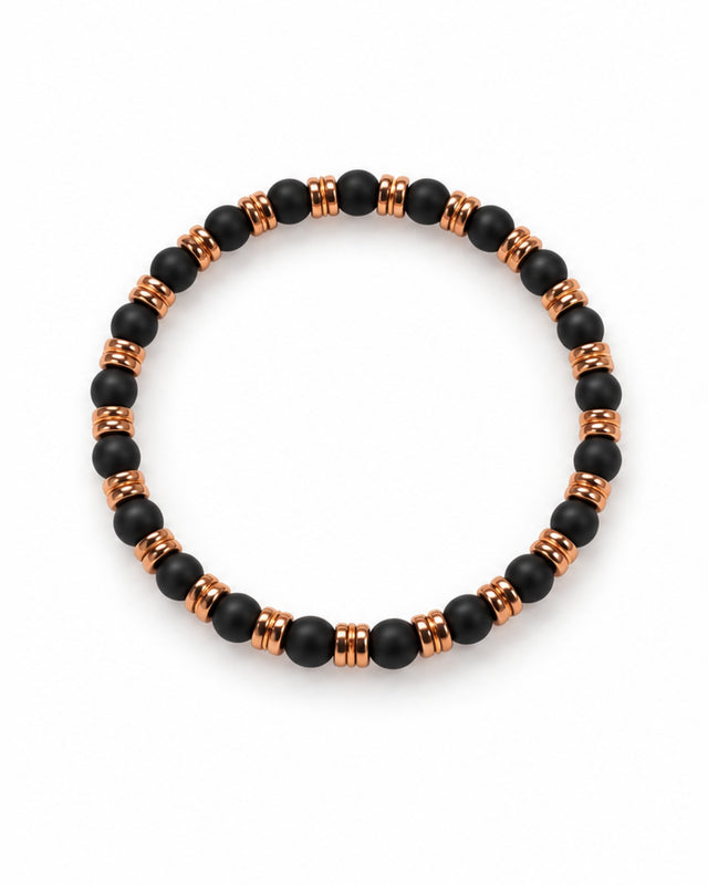 A circular bracelet featuring black matte beads interspersed with metallic copper accents.