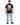 A man wearing a black t-shirt with a graphic design featuring two seated figures and decorative elements on the back.