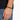 A close-up of a hand wearing a black beaded bracelet, showcasing a simple and modern design.
