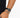 A close-up of a wrist featuring a beaded bracelet with gray and black stones, paired with a sleek watch.