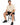 A man sits on a black stool, wearing a beige t-shirt and black shorts, paired with black sneakers.