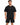 A man wearing a black oversized t-shirt with a graphic design, paired with matching black shorts.