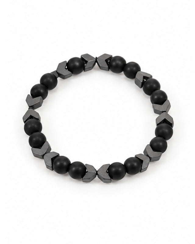 Black beaded bracelet featuring smooth round beads and angular metallic accents for a modern look.