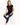 A woman sits on a white stool wearing a black sleeveless top with a heart design, paired with distressed blue jeans a...