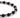 A close-up of a beaded bracelet featuring alternating matte black and shiny silver spherical beads.