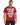 A man wearing a red t-shirt with bold white text that reads "Pursue Your Highest Self," paired with dark jeans.
