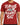 A red t-shirt featuring bold white graffiti-style text with an inspirational message and a graphic logo.