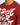 A close-up of a red t-shirt featuring bold white graffiti-style text and a graphic patch on the front.
