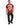 A man stands wearing a red graphic t-shirt with bold white text and black jeans, showcasing a casual style.