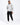 A man stands confidently in a light gray hoodie with a graphic design, paired with black cargo joggers and white snea...
