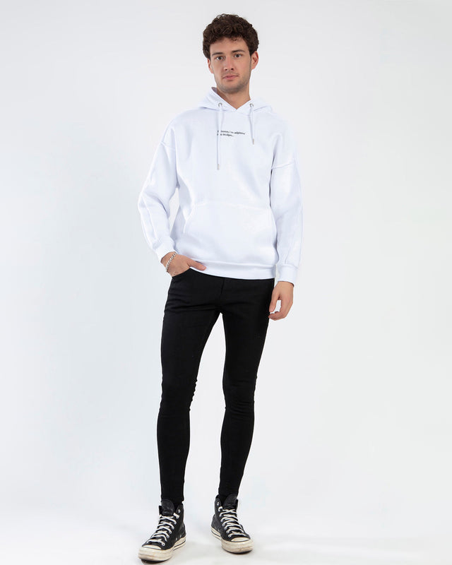Male model wearing the White I AM Hoodie with chest text, black skinny jeans, and high-top sneakers.
