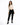 A model poses in a fitted beige long-sleeve top with cut-out details, paired with black skinny jeans and sneakers.