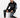 A man sits on a white cube wearing black sweatpants with graphic prints and a matching hoodie, paired with black snea...