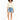 A model with curly hair wears a light-colored cropped top and distressed denim shorts, paired with white sneakers.