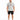 A man stands wearing a light gray t-shirt with a colorful graphic design, paired with black shorts and sneakers.