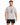 A man wearing a light gray t-shirt with colorful graphic text and black shorts, standing against a white background.