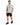A man stands wearing a light gray t-shirt with colorful graphic designs, paired with black denim shorts and sneakers.