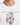 White t-shirt featuring colorful, playful text and motivational phrases in a bold, graphic design.