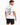 A man wearing a white t-shirt with colorful text and graphic designs on the back, paired with dark shorts.