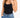 A woman wearing a black tank top and high-waisted blue jeans, showcasing a colorful beaded bracelet on her wrist.