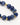 A close-up of a bracelet featuring deep blue spherical beads interspersed with gold accents.