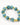Turquoise and black speckled beads interspersed with gold accents form a stylish bracelet.