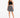 A model wears a black crochet crop top paired with a flowy black and white patterned skirt and strappy heels.