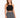 A woman models a black crochet halter top paired with a patterned black and white skirt.