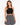 A woman models a black crochet halter top paired with a patterned black and white skirt.