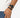 A braided black bracelet worn alongside a sleek black watch on a person's wrist.