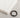 Braided brown bracelet with a black clasp beside neatly folded white clothing on a textured surface.