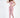 A model poses in a pink cut-out bodysuit and matching joggers, styled with white sneakers.