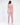 A woman with long hair wears a pink sleeveless top and matching joggers, showcasing a stylish cutout design.