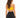 A woman with long, wavy hair wears a yellow crop top and black high-waisted leggings, viewed from the back.