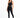A model poses in a sleek black one-shoulder activewear top paired with matching leggings and sneakers.