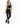 A model poses in a sleek black one-shoulder activewear top paired with matching leggings and black sneakers.