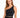 A woman models a fitted black activewear top with a stylish one-shoulder design and cropped length.