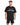 A man stands wearing a black oversized t-shirt with graphic text and matching black shorts featuring a large number.