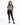 A woman stands wearing a gray tie-dye tee featuring a tiger graphic, paired with black skinny jeans and sneakers.
