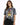 A woman wearing a tie-dye t-shirt featuring a bold tiger graphic, paired with black jeans.