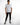 A model stands confidently in a white short-sleeve shirt with "REVOLUTION" text, paired with black jeans and stylish...