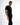 A model poses in a fitted black t-shirt featuring bold text and a motivational quote along the side.
