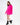 Brooke hot pink oversized knit sweater with elbow cut-outs, styled with black platform boots on white background.
