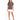 A woman stands confidently in a gray t-shirt with a stylish graphic, paired with a white skirt and black heels.